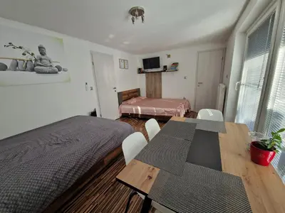 a room with a table and a bed and a bedroom at Apartment Dolce Vita in Celje