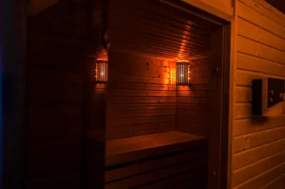a sauna with two lights on the wall at Apartment Dolce Vita in Celje