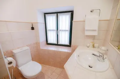 a bathroom with a toilet and a sink at Pri Žabarju Bed & Breakfast Ljubljana in Ljubljana