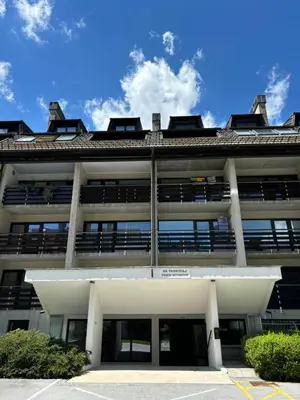 a large white building with a lot of windows at Apartman Veriga in Kranjska Gora