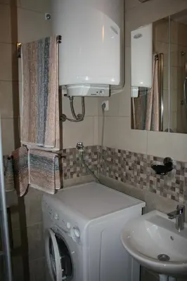 a bathroom with a washing machine and a sink at Apartman Veriga in Kranjska Gora