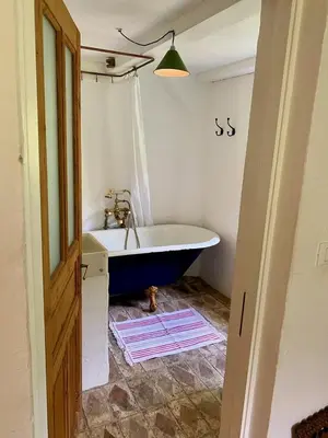 a bathroom with a bath tub and a sink at Klavze 28 in Most na Soči