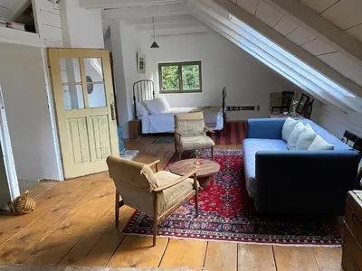 a living room with a blue couch and chairs at Klavze 28 in Most na Soči
