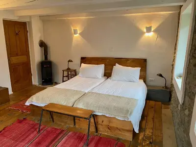 a bedroom with a large bed with a wooden headboard at Klavze 28 in Most na Soči