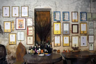 a wall filled with lots of bottles of wine at Apartmaji pri Živcovih in Dutovlje