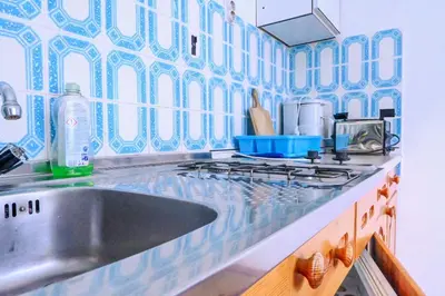 a kitchen counter with a sink and a stove at Guest House Ivanka in Bled
