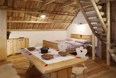 a room with a table and a bed at Alpine Homestead in Goreljek