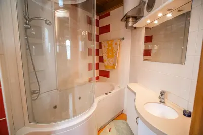 a bathroom with a shower and a sink and a toilet at Holiday Home Mirt with HotTub & Sauna in Blanca
