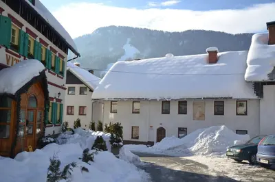 a snow covered street in a town with buildings at Apartments Pr'Krštano in Kranjska Gora