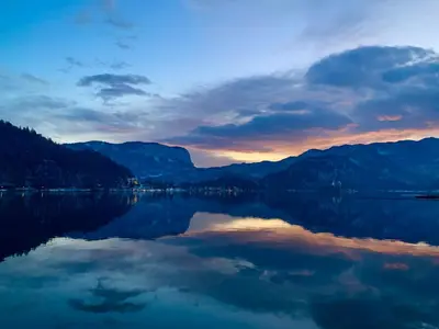 a view of a lake at sunset at STATUS Apartments in Bled