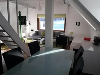 a living room with a white table and chairs at Apartments Podkoren 82 in Kranjska Gora