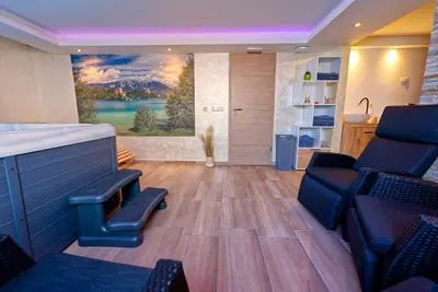 a living room with a large painting on the wall at APARTMENT PETEK in Bled