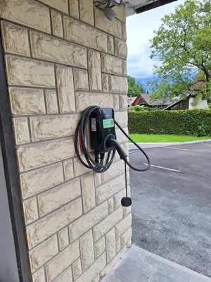 a pay phone on the side of a brick wall at APARTMENT PETEK in Bled