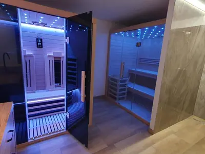 a bathroom with a walk in shower and a mirror at APARTMENT PETEK in Bled