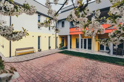 a brick courtyard of a building with a bench at Vila Anna in Radenci