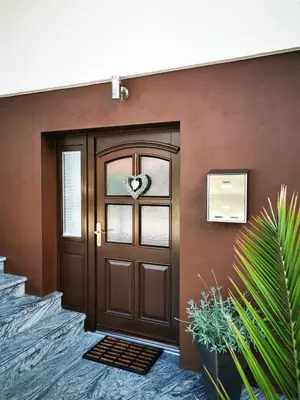 a brown door with a heart on the window at Studio Jan in Zgornje Gorje