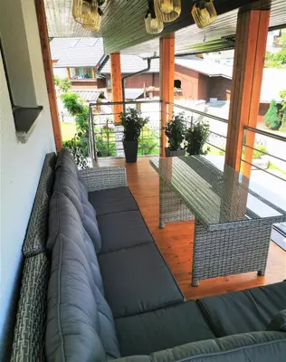 a living room with a couch and a glass table at Studio Jan in Zgornje Gorje