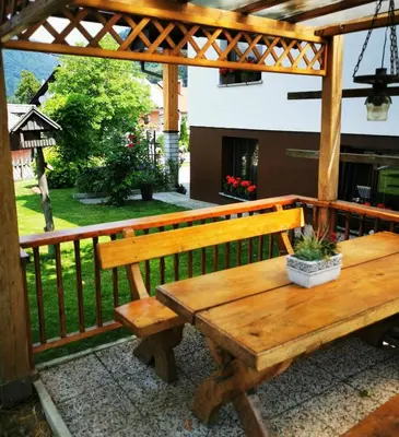 a wooden bench sitting on top of a porch at Studio Jan in Zgornje Gorje