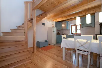a kitchen and dining room with a table in a room at Apartments Tonkli in Logje