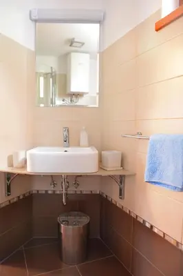 a bathroom with a sink and a mirror at Apartments Tonkli in Logje