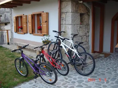 three bikes parked outside of a building at Apartments Tonkli in Logje
