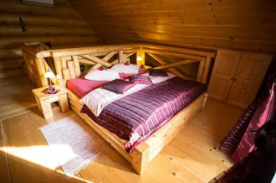 an overhead view of a bed in a log cabin at Korošec Apartments and Wellness Centre in Mozirje