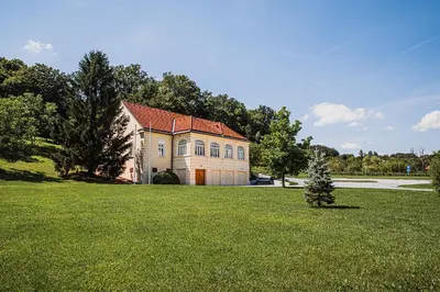 a large house in a field of green grass at Villa Istenič in Bizeljsko