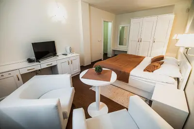 a bedroom with a bed and a table and chairs at Villa Istenič in Bizeljsko