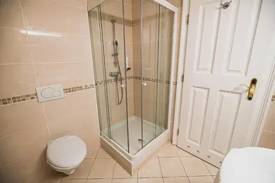 a bathroom with a shower and a toilet and a shower backdoor at Villa Istenič in Bizeljsko