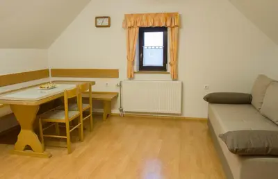 a living room with a couch and a table at Apartments Pri Marjetki in Cerkno