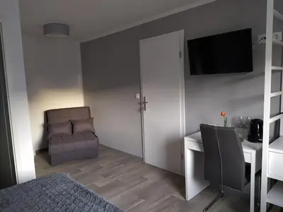a bedroom with a bed and a desk and a chair at Apartment Trubarjeva33, near Ljubljana, free parking in Velike Lašče