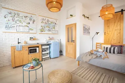 a bedroom with a bed and a sink and a kitchen at Funky soul studio in Žirovnica