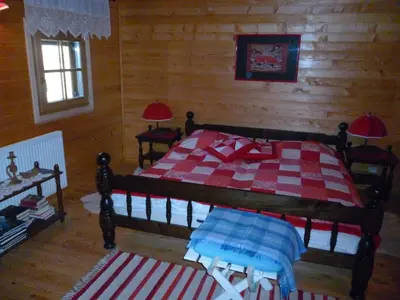 a bedroom with a bed with a red and white blanket at Chalet Bellevue Rogla in Zreče