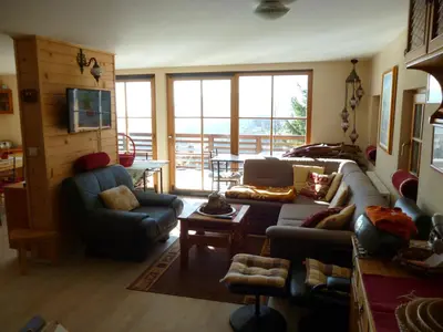 a living room with a couch and chairs and a television at Chalet Bellevue Rogla in Zreče