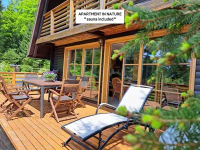 a wooden deck with a table and chairs on it at Chalet Bellevue Rogla in Zreče