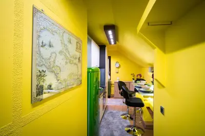 a room with yellow walls and a green refrigerator at Apartment Jacobs in Bled