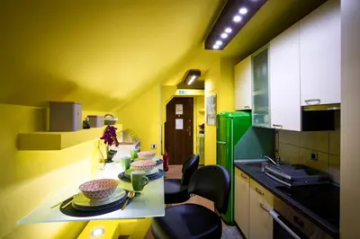 a kitchen with yellow walls and a table with dishes on it at Apartment Jacobs in Bled