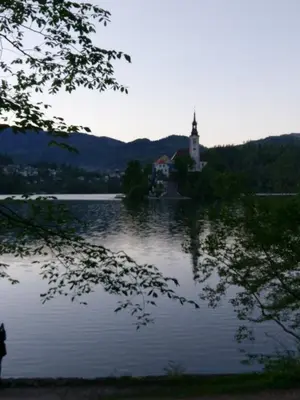 a reflection of a church in a lake at Apartment Jacobs in Bled