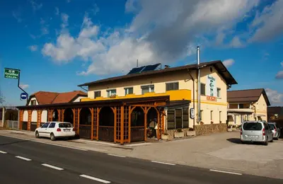 a building on a street with cars parked in front of it at Guest House Čelan in Spodnja Hajdina