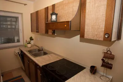 a kitchen with a sink and a stove at Guest House Čelan in Spodnja Hajdina