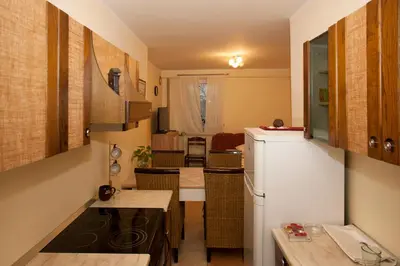 a small kitchen with a refrigerator and a table at Guest House Čelan in Spodnja Hajdina