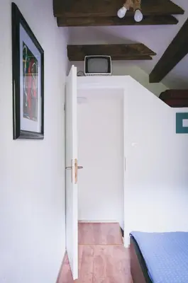 a room with a white door and a bed at NATURALINA HOLIDAY HOUSE in Tribussa Superiore