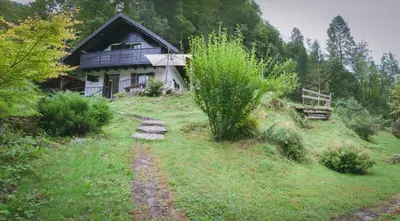 a house on the side of a grassy hill at NATURALINA HOLIDAY HOUSE in Tribussa Superiore