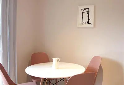a white table with chairs and a vase on it at Apartments Alteri Domi in Bohinj
