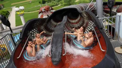 a group of children riding on a roller coaster at Terme Olimia - Hotel Breza in Podčetrtek