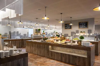 a restaurant with a buffet line with food at Terme Olimia - Hotel Breza in Podčetrtek