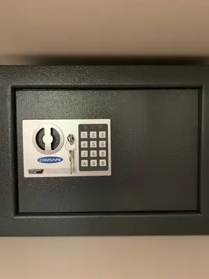 a black microwave with a clock and keys on it at Royal Vega Apartment in Ljubljana