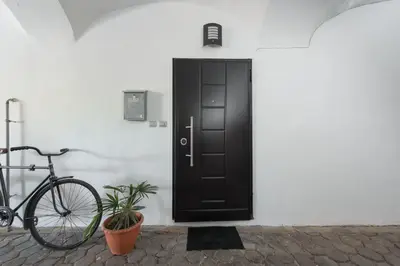 a bike parked in front of a black door at Royal Vega Apartment in Ljubljana
