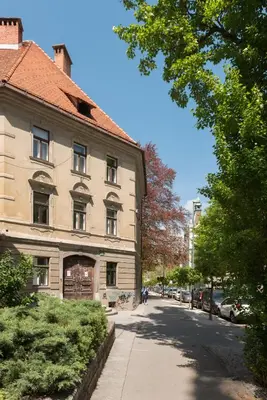 an old building on the side of a street at Royal Vega Apartment in Ljubljana