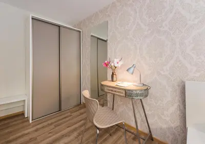 a room with a desk with a lamp and a chair at Royal Vega Apartment in Ljubljana